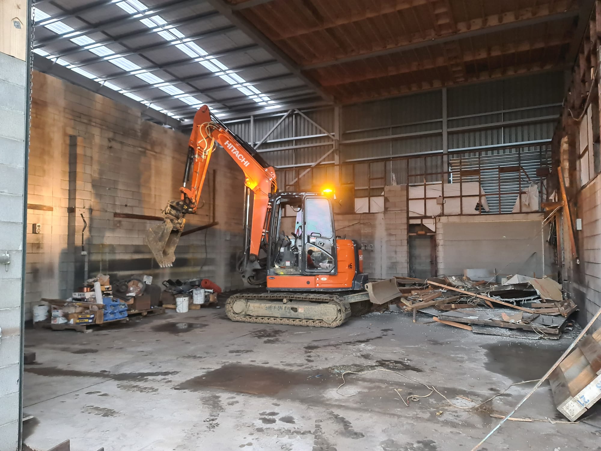 Excavator working inside a commercial building