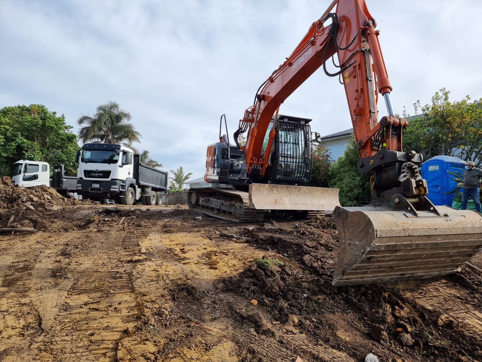 Excavator and truck preparing a residential site